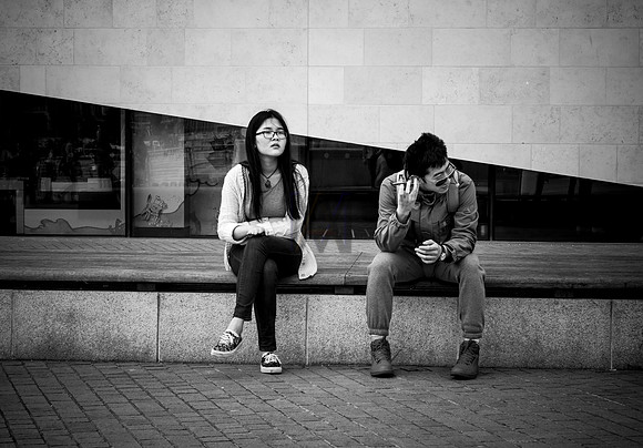 Two friends sit wait for a call. By Preston street photographer Alf Myers