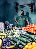 A Greek market stall holder looks over his products  by Preston based street photographer Alf Myers