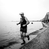A runner running alongside the sea in Thessaloniki, Greece. Image by Preston based street photographer Alf Myers