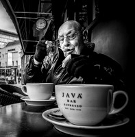 Street Photography by Alf Myers - a man takes a sip of coffee from his spoon