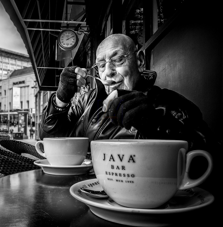 Street Photography by Alf Myers - a man takes a sip of coffee from his spoon
